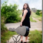 Senior girl with guitar case senior girl on country road