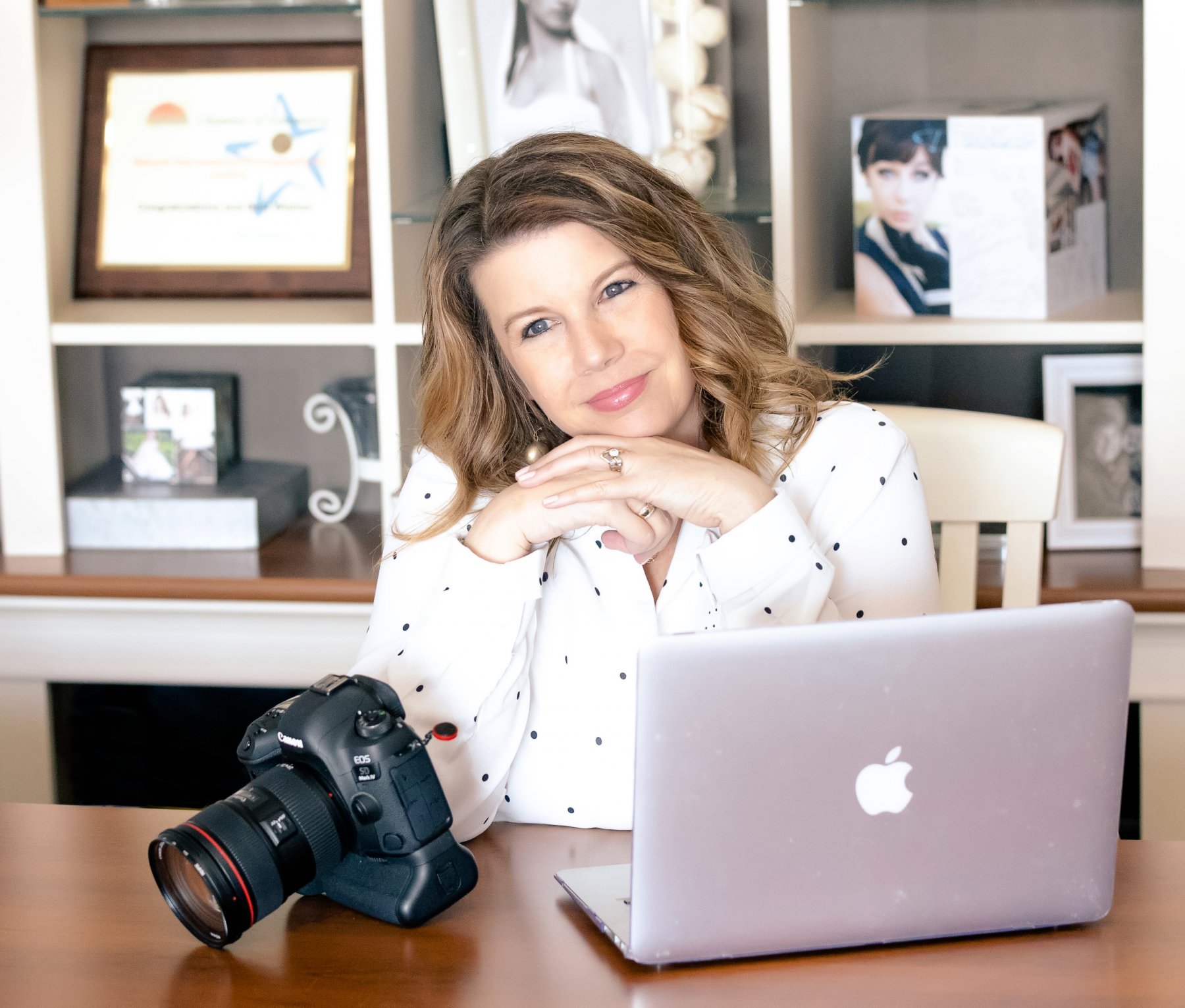 Photo of Justine at desk with camera and computer Photographer in Bismarck ND