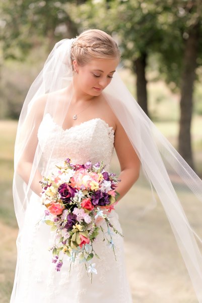 Bismarck bride in cathedral veil and summer colorful bouquet.   Photo taken by Photography by Justine Bismarck Wedding Photographer